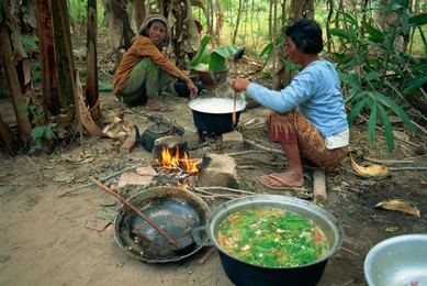 Woman cooking over camp fire, Cambodia, Indochina, Southeast Asia, Asia