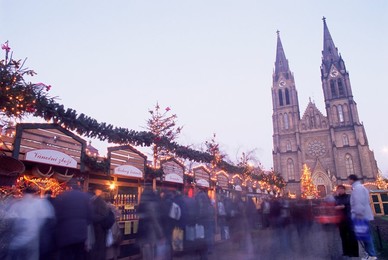 Christmas decoration at market on namesti Miru (Square) and neo-Gothic St. Ludmilla Church at twilight, Vinohrady, Prague, Czech Republic, Europe