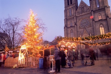 Christmas decoration at market on namesti Miru (square) and neo-Gothic St. Ludmilla church at twilight, Vinohrady, Prague, Czech Republic, Europe