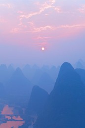 Karst landscape, Li Jiang (Li River) and rising sun, Yangshuo, Guangxi Province, China, Asia