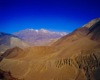 Arid landscape and colourful mountains, on route from KaGBeni to Khingar, Southern Mustang, Nepal