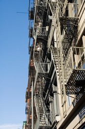 Fire escapes on the outside of buildings in Spring Street, Soho, Manhattan, New York City, New York, United States of America, North America