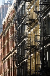 Fire escapes on the outside of buildings in Spring Street, Soho, Manhattan, New York City, New York, United States of America, North America