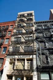 Fire escapes on the outside of buildings in Spring Street, Soho, Manhattan, New York City, New York, United States of America, North America