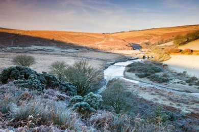 Sunlight thaws the frosted moorland landscape near Landacre Bridge, Exmoor National Park, Somerset, England, United Kingdom, Europe
