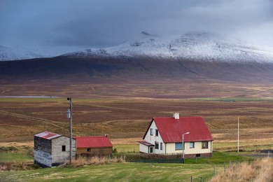 Farm and landscape in Vatsnes Peninsula, with snow-covered mountains in October, north coast of Iceland, Iceland, Polar Regions