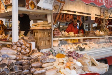 Stall selling cheese, fruit cake and sausages at Christmas Market on Maxheinhardtplatz, Salzburg, Austria, Europe