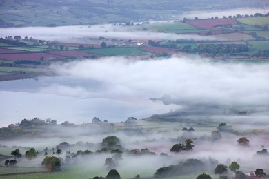 Mist shrouded Llangose Lake and surrounding landscape at dawn, Brecon Beacons National Park, Powys, Wales, United Kingdom, Europe