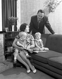 Family group looking at a brochure, Doncaster, South Yorkshire, 1963.