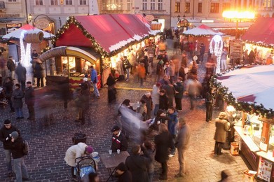 Stalls and people at Christmas Market at dusk, Old Town Square, Stare Mesto, Prague, Czech Republic, Europe