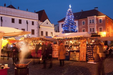 Christmas Market stalls and Christmas tree at twilight, Svornosti Square, Cesky Krumlov, Ceskobudejovicko, Czech Republic, Europe