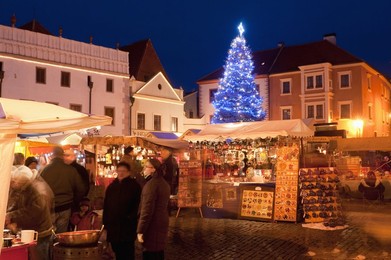 Christmas Market stalls and Christmas tree at twilight, Svornosti Square, Cesky Krumlov, Ceskobudejovicko, Czech Republic, Europe
