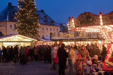 Christmas Market with stalls, people and Christmas tree at twilight, Markt Square, Annaberg-Bucholz, Saxony, Germany, Europe