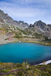 Imperial Tarn with its colorful aqua tint due to glacial flour, in the cirque of Royal Basin in Olympic National Park, Washington State, USA.