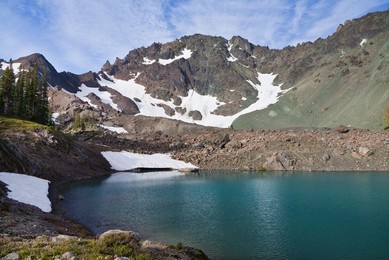 Imperial Tarn with its colorful aqua tint due to glacial flour, looking toward Mt. Deception, in the cirque of Royal Basin in Olympic National Park, Washington State, USA.
