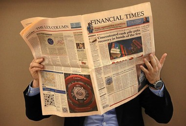 Reading the newspaper at the Annual Meet..........