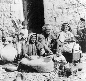 Palestine: A Happy Palestinian family of Ramallah with a crying toddler, early 20th century