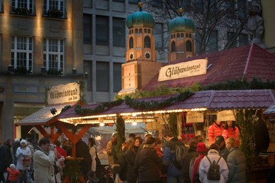 People at a Gluhwein stall at the Christmas Market.