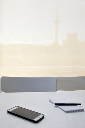 Note pad, pen and mobile phone on office desk