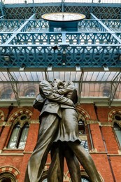 Paul Day's Meeting Place statue, known as the Lovers, St. Pancras, historic Victorian Gothic railway station, London, England, United Kingdom