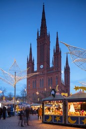 Christmas market and Marktkirche (Market Church) at dusk, Wiesbaden, Hesse, Germany