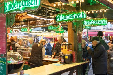 People at German mulled wine stall at Frankfurt Christmas Market, Frankfurt am Main, Hesse, Germany