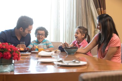 Happy family eating a meal at the table