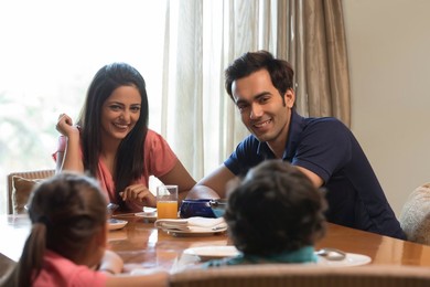 Happy family eating a meal at the table
