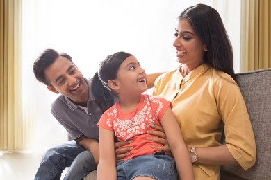 Happy family having fun together on sofa