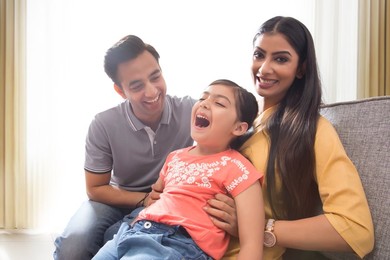 Happy family having fun together on sofa