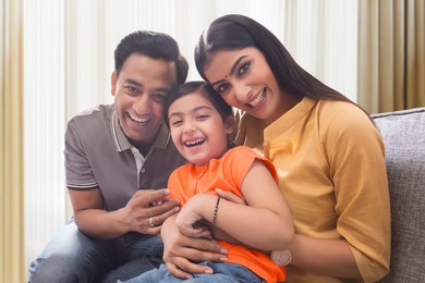 Happy family having fun together on sofa