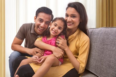 Happy family having fun together on sofa