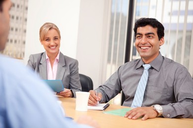Business executives smiling in a meeting