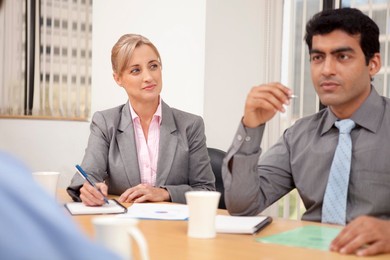 Female executive taking notes in a meeting
