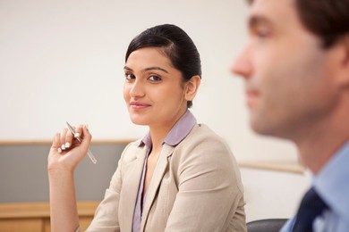 Portrait of a female executive in a meeting