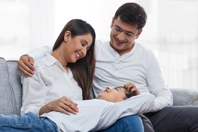 Happy young family on sofa