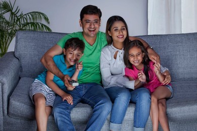 Happy family watching television together