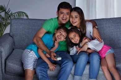Happy family watching television together