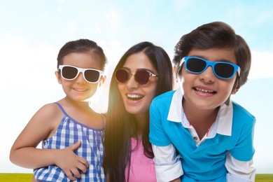 Happy family wearing sunglasses enjoying in park