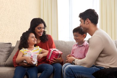 Happy family holding a gift box