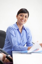 Smiling young female executive in a meeting