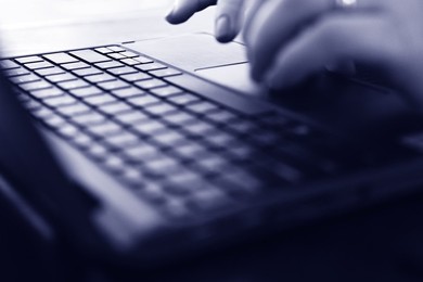Woman hands typing on laptop in monochrome color
