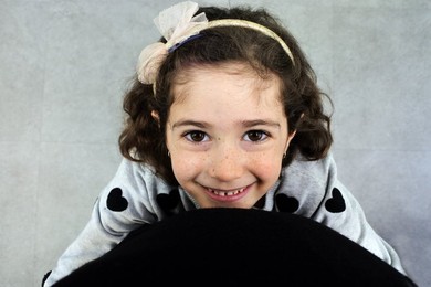 Father looking down at his happy young daughter