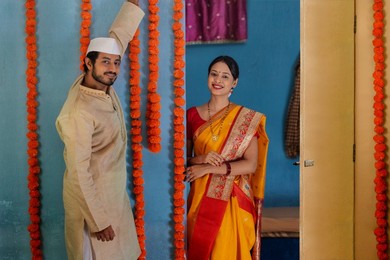 Maharashtrian couple decorating house on festival