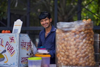 Portrait of a smiling male street vendor looking elsewhere