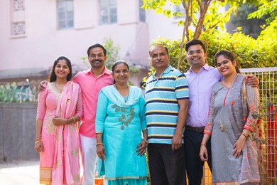 Portrait of happy family members standing in front of gate