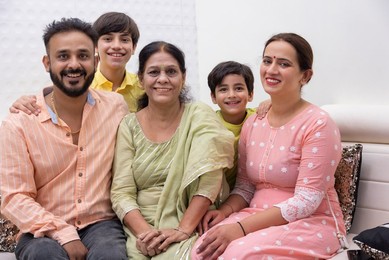 Portrait of happy family sitting together at home