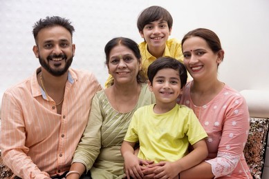 Portrait of happy family sitting together at home
