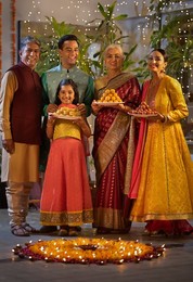 Happy family posing together whilist holding sweets
