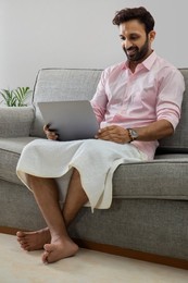 Man working from home and attending an office meeting on video call